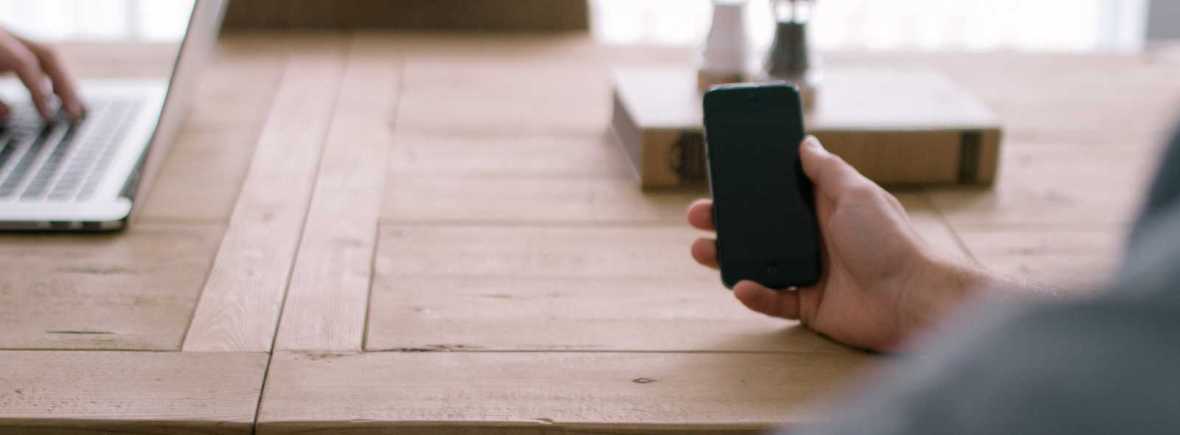 hand holds a mobile phone